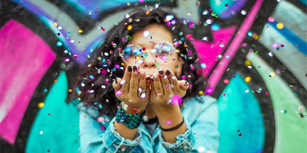 Woman catching colorful-confetti with her hands-photo_hugo-ruiz-1